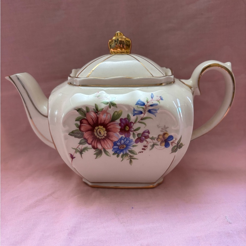 Vin Sadler Cube Floral Teapot with Gold Accents measures 41/2x7” widest point.